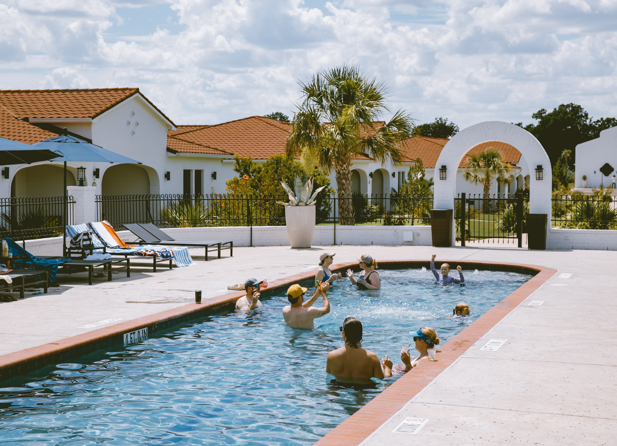 Guests enjoying the pool at La Palmilla